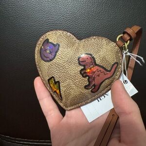 Heart Puffy Bag Charm
In Signature Canvas With Coach Limited stickers